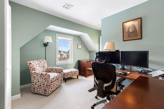 home office with lofted ceiling and carpet