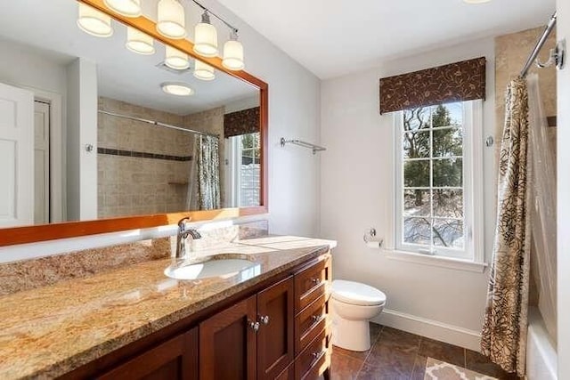 full bathroom featuring vanity, a wealth of natural light, tile patterned floors, and toilet