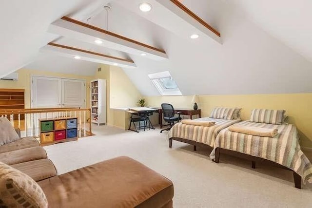 carpeted bedroom featuring vaulted ceiling with skylight