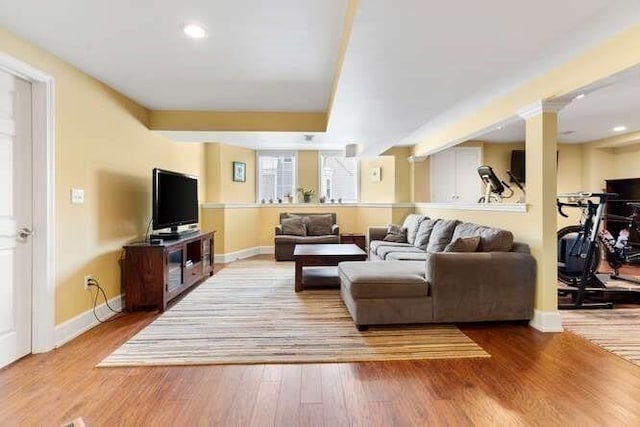 living room with hardwood / wood-style flooring and ornate columns