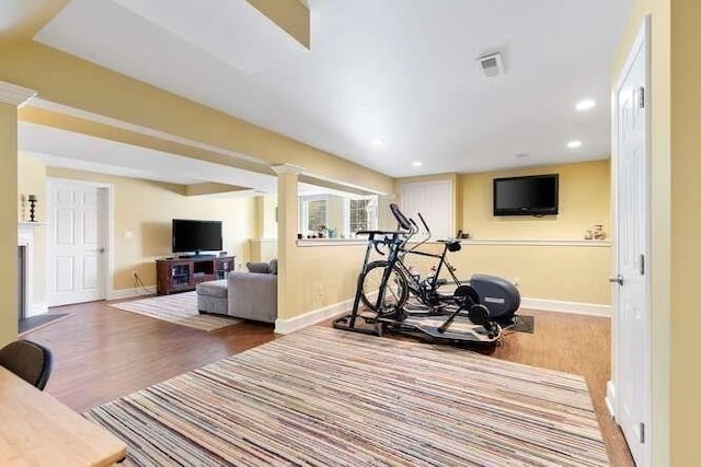 exercise room with hardwood / wood-style flooring