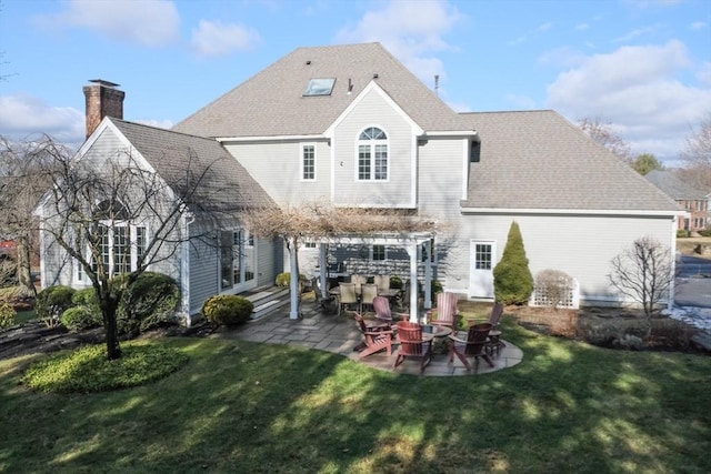 rear view of property featuring a yard and a patio area