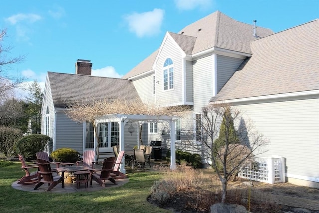 back of property featuring a pergola, a patio area, a lawn, and an outdoor fire pit