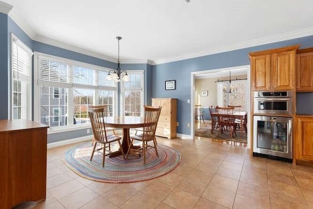 tiled dining area with crown molding, beverage cooler, and a chandelier