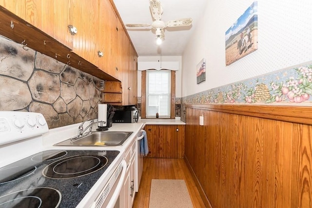 kitchen featuring white electric range, sink, light hardwood / wood-style flooring, dishwasher, and ceiling fan