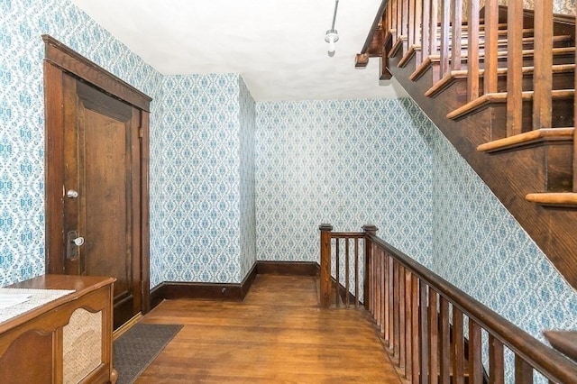 hallway with dark hardwood / wood-style floors