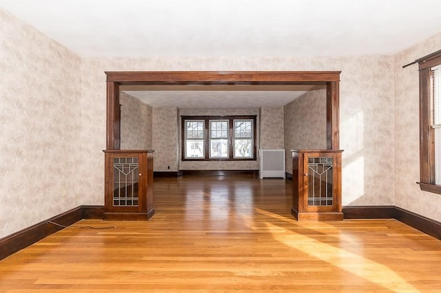 unfurnished living room featuring wood-type flooring