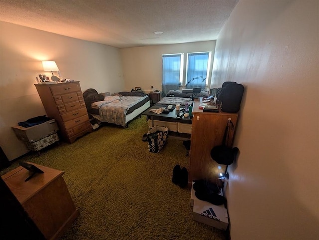 bedroom featuring a textured ceiling and carpet