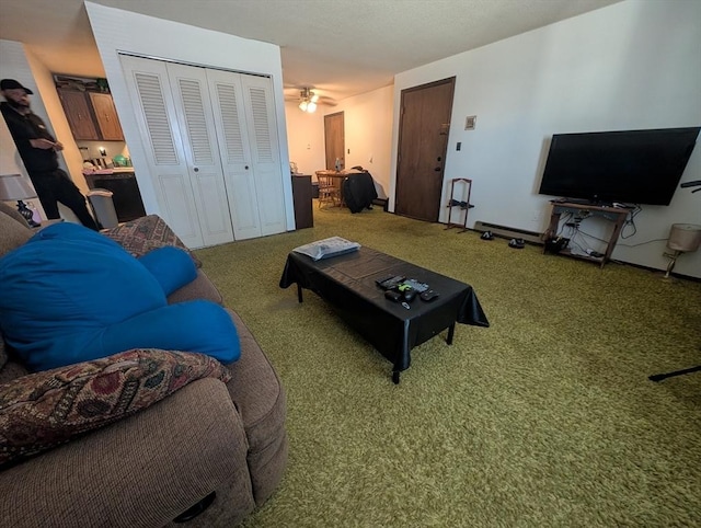 carpeted living area featuring a ceiling fan