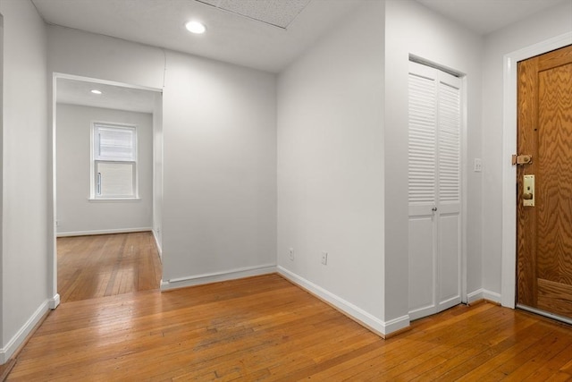 entrance foyer featuring hardwood / wood-style flooring, baseboards, and recessed lighting