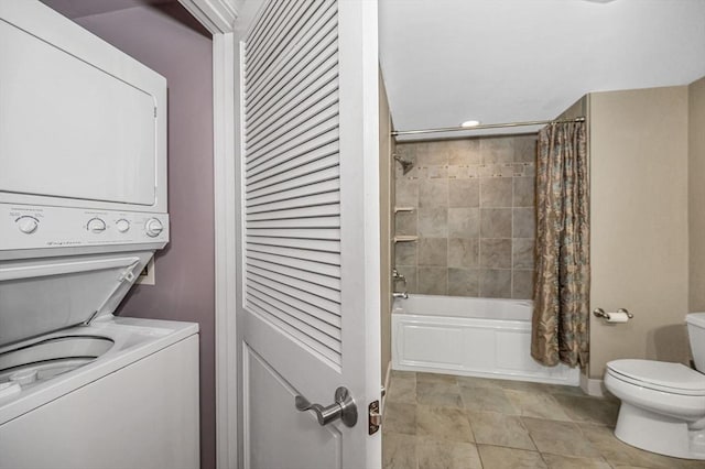 laundry area with light tile patterned floors and stacked washer / drying machine