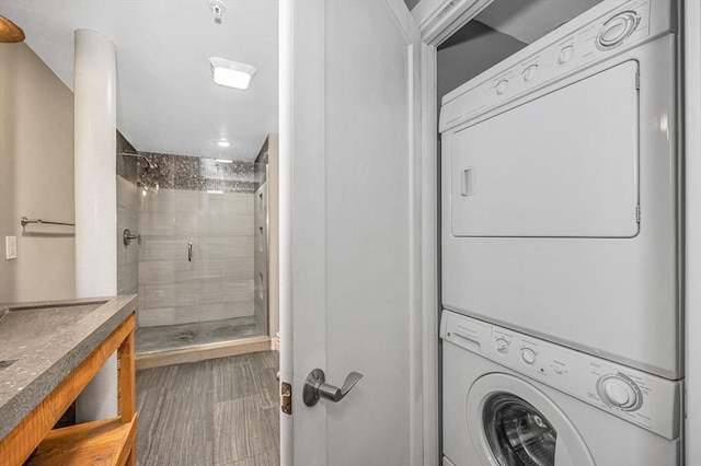 interior space featuring laundry area, stacked washer / drying machine, and dark wood-style flooring