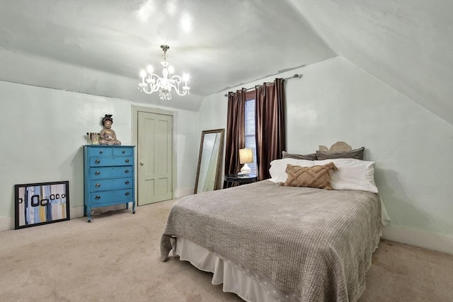 bedroom featuring light carpet, an inviting chandelier, a closet, and vaulted ceiling