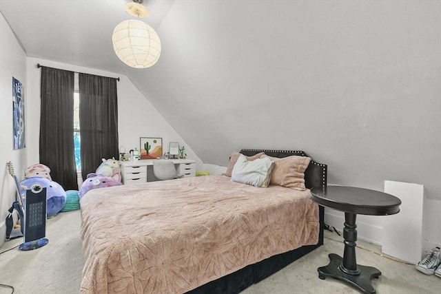 carpeted bedroom featuring lofted ceiling