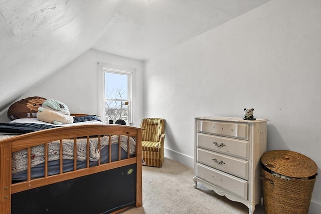 carpeted bedroom featuring lofted ceiling and baseboards