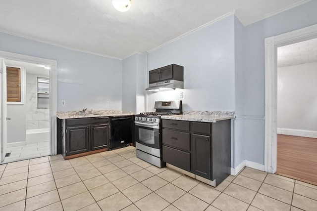 kitchen featuring crown molding, under cabinet range hood, stainless steel range with gas stovetop, dishwasher, and light tile patterned floors