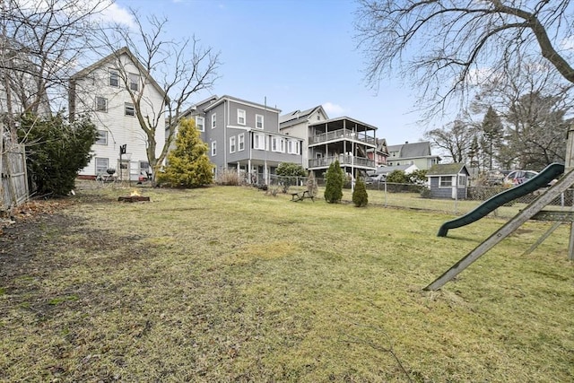 view of yard featuring a playground and fence