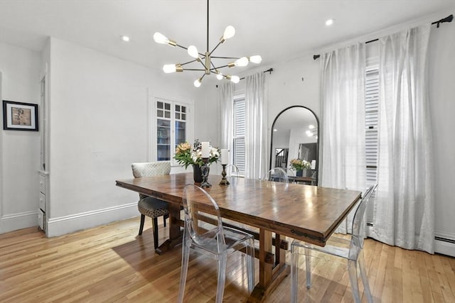 dining space with a chandelier, recessed lighting, light wood-type flooring, and baseboards