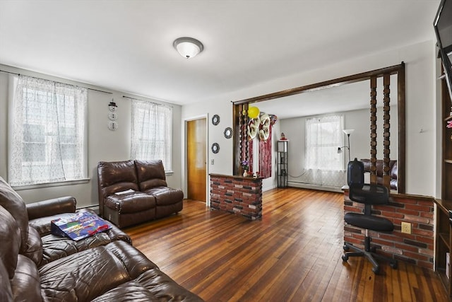 living room featuring baseboard heating and hardwood / wood-style flooring