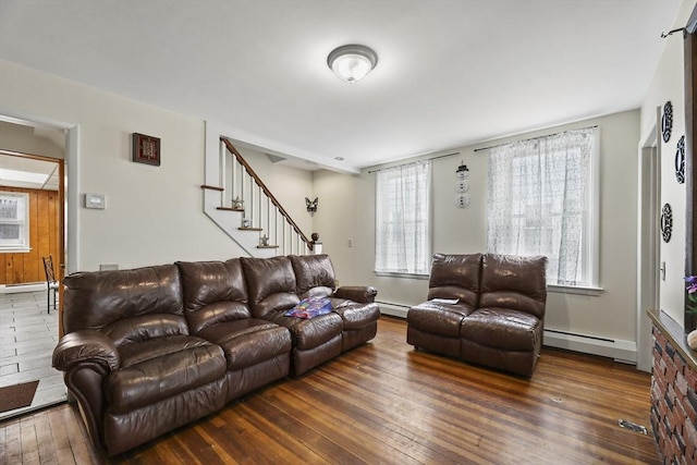 living room featuring a baseboard radiator, a baseboard heating unit, hardwood / wood-style floors, and stairs