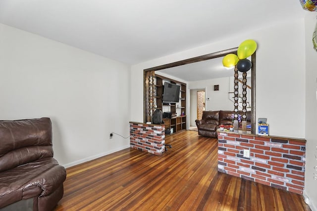 living area with wood finished floors and baseboards