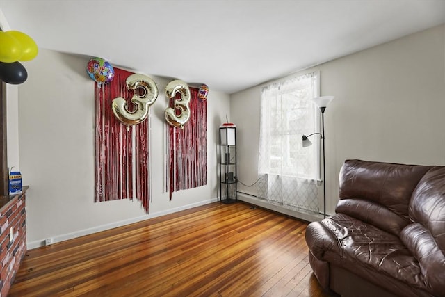 living room with baseboards and wood-type flooring