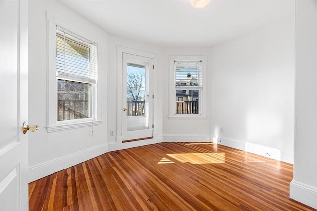 unfurnished room with hardwood / wood-style floors