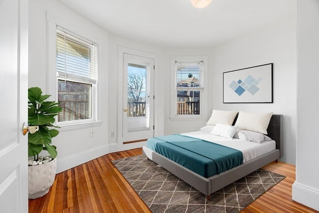 bedroom featuring hardwood / wood-style floors and access to outside