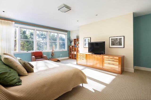 bedroom featuring light carpet