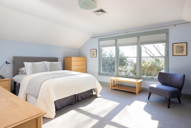 bedroom featuring lofted ceiling and carpet flooring