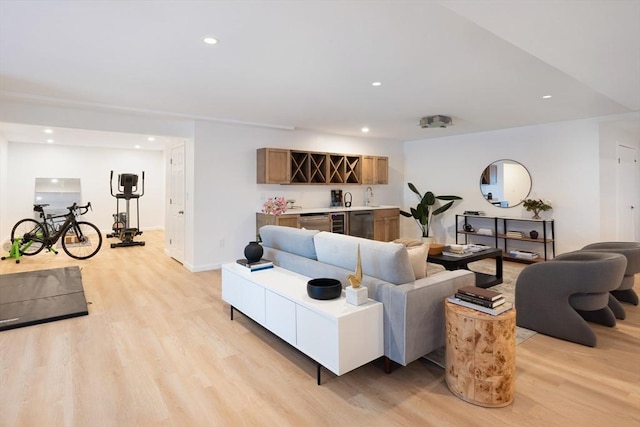 living room featuring bar area and light hardwood / wood-style flooring