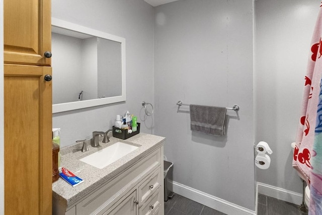 bathroom featuring baseboards and vanity