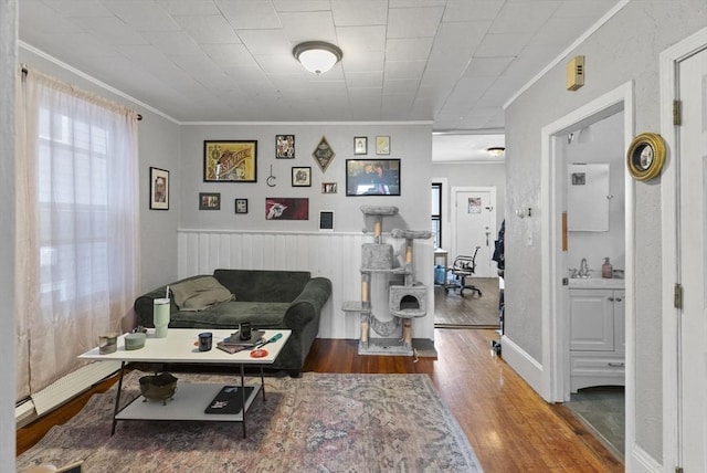 interior space with wood finished floors and crown molding