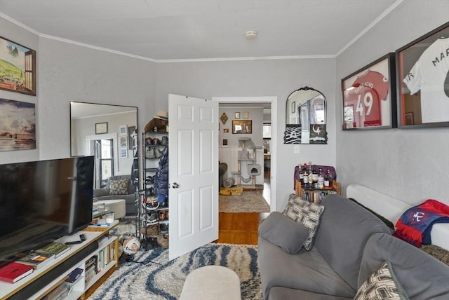 living room featuring wood finished floors and crown molding