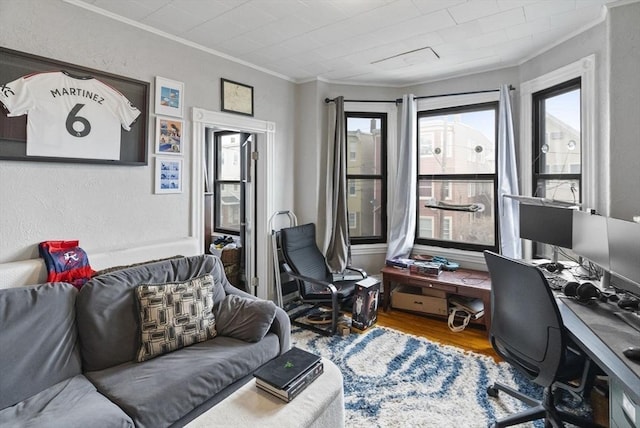 office space with a textured wall, ornamental molding, and wood finished floors