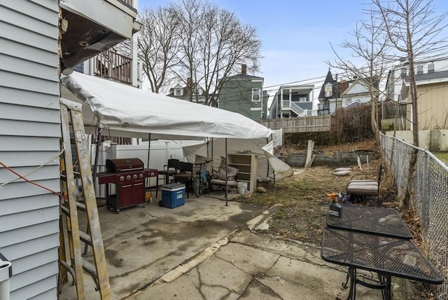 view of patio featuring fence and area for grilling