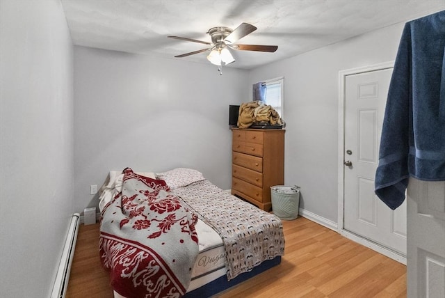 bedroom with light wood-type flooring, a baseboard radiator, ceiling fan, and baseboards