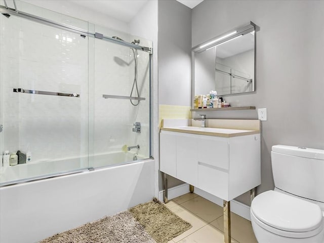 full bathroom with vanity, toilet, bath / shower combo with glass door, and tile patterned flooring