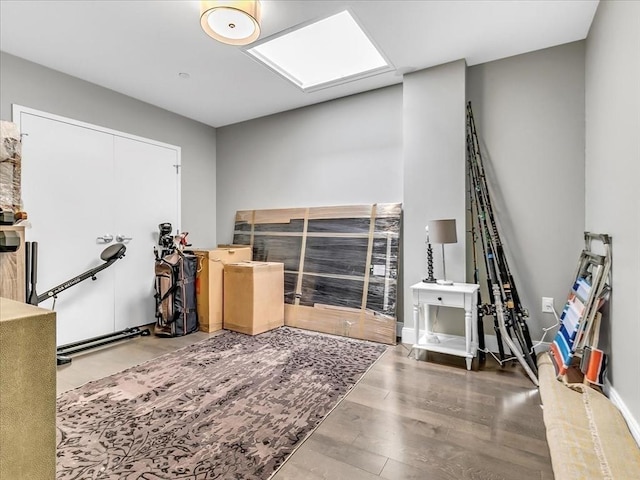 game room with baseboards and wood finished floors