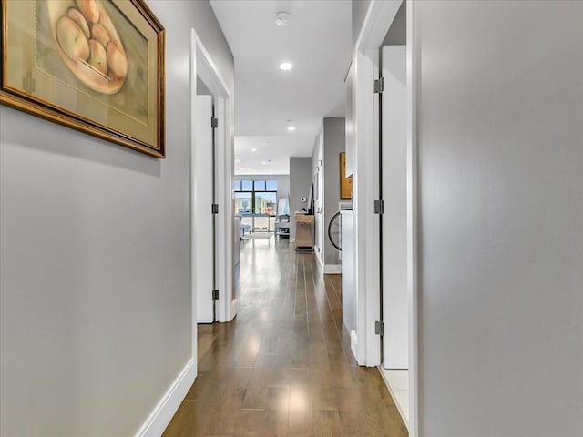 corridor with recessed lighting, baseboards, and dark wood finished floors