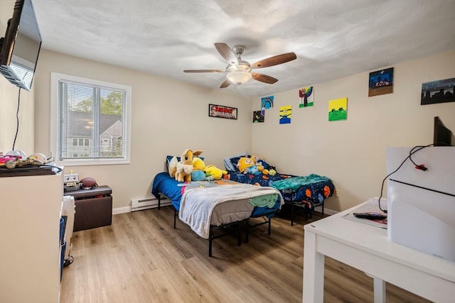 120 Eldridge St Unit 5, Taunton, MA 02780 - bedroom featuring a baseboard heating unit, light wood-style flooring, baseboards, and ceiling fan