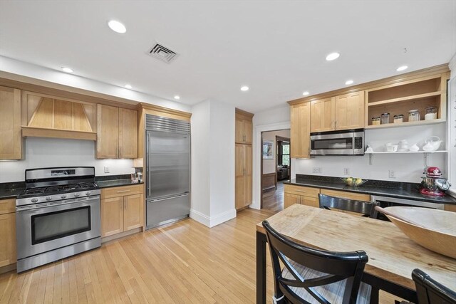 4 Fairbanks Unit 2, Brookline, MA 02446 - kitchen featuring stainless steel appliances, visible vents, custom range hood, and light wood-type flooring