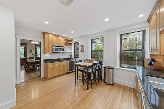 4 Fairbanks Unit 2, Brookline, MA 02446 - kitchen featuring open shelves, beverage cooler, light wood-style floors, stainless steel microwave, and a wealth of natural light