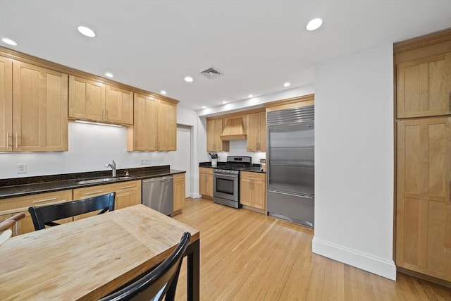 4 Fairbanks Unit 2, Brookline, MA 02446 - kitchen with visible vents, dark countertops, a sink, light wood-style flooring, and stainless steel appliances