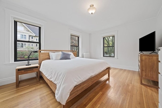 4 Fairbanks Unit 2, Brookline, MA 02446 - bedroom featuring baseboards, light wood-style flooring, and radiator