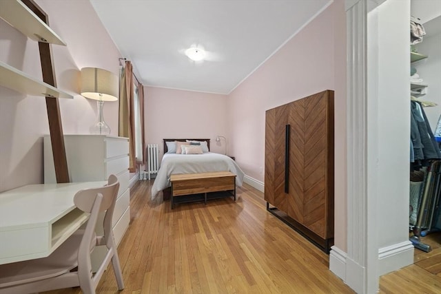4 Fairbanks Unit 2, Brookline, MA 02446 - bedroom featuring baseboards, light wood-style flooring, and radiator