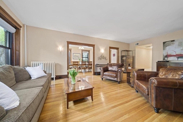 4 Fairbanks Unit 2, Brookline, MA 02446 - living room with visible vents, light wood-style flooring, and radiator