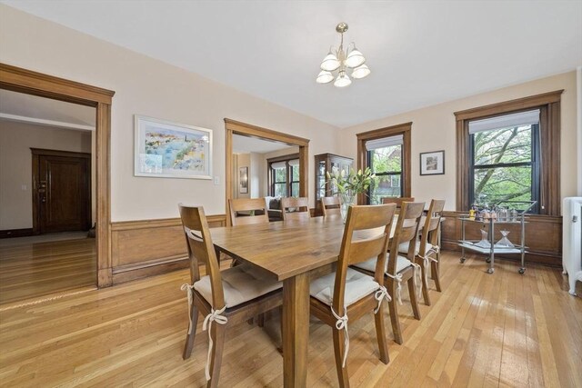 4 Fairbanks Unit 2, Brookline, MA 02446 - dining room featuring light wood finished floors, a wainscoted wall, and a chandelier
