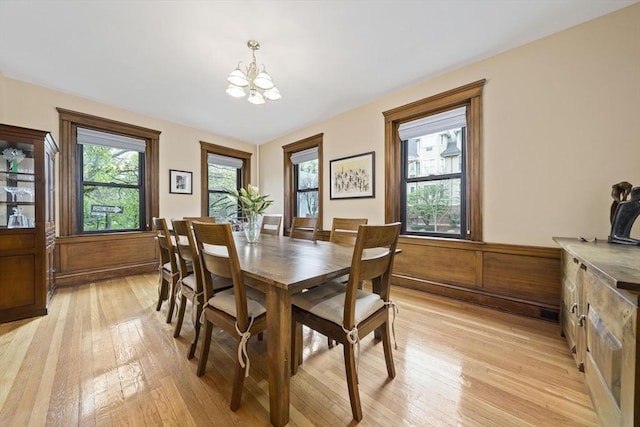 4 Fairbanks Unit 2, Brookline, MA 02446 - dining space with wainscoting, light wood-style flooring, and a chandelier