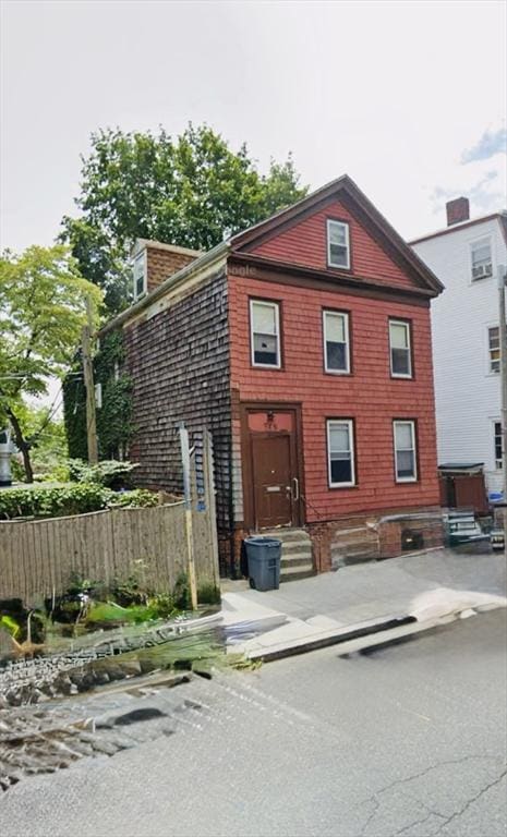 rear view of property with fence